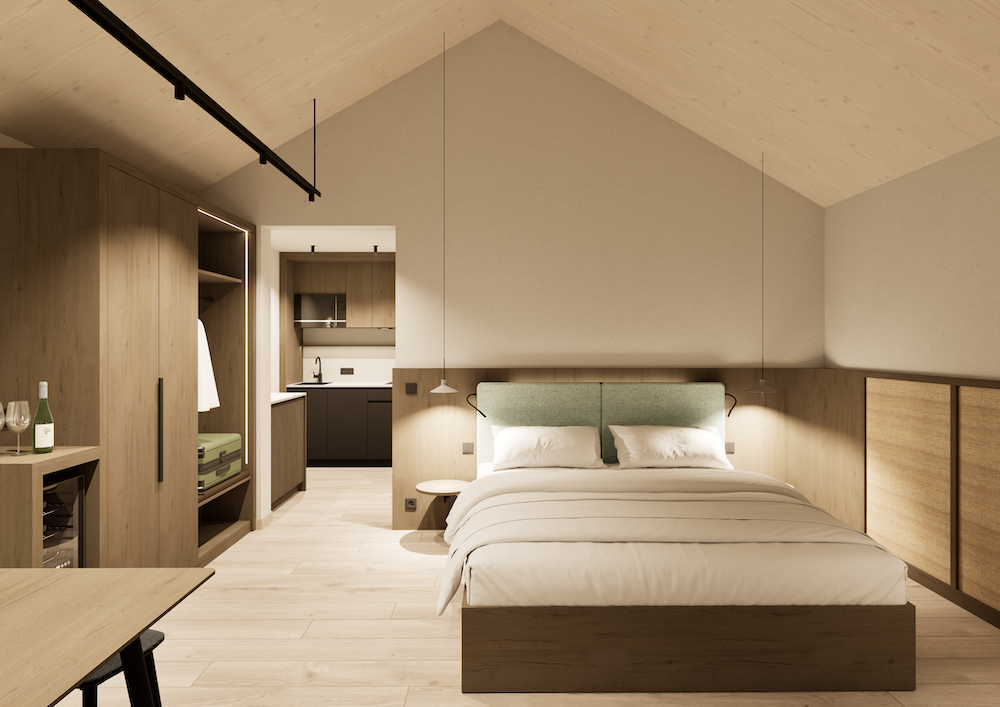 Ein modernes Winzerhäuser Zimmer mit einer hellen Holzschrägdecke, einem Doppelbett mit weißer Bettwäsche, einem eingebauten Holzkleiderschrank und einer offenen Küchenzeile im Hintergrund. Neutrale Töne und minimalistisches Dekor schaffen eine ruhige Atmosphäre.